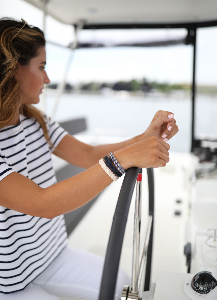 Woman wearing Lemon and Line nautical rope bracelets by the water