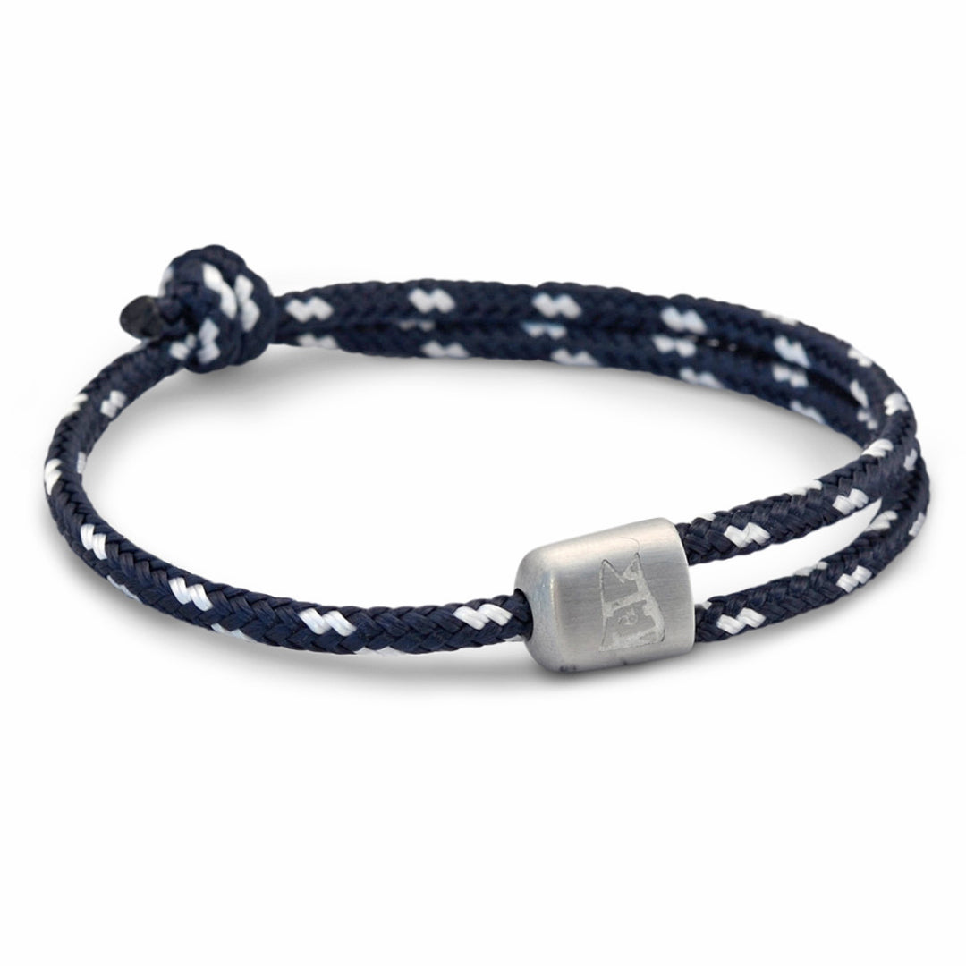 The Cuttyhunk Collection: An adjustable navy and white nautical rope bracelet in custom USA-made double braid line with 316L stainless steel hardware.