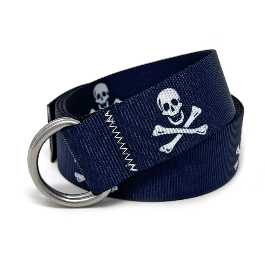 Jolly Roger Belt: A navy blue 1.5" marine-grade webbing belt with pirate flag motif, signature zig-zag stitching, and 316L stainless steel d-rings.